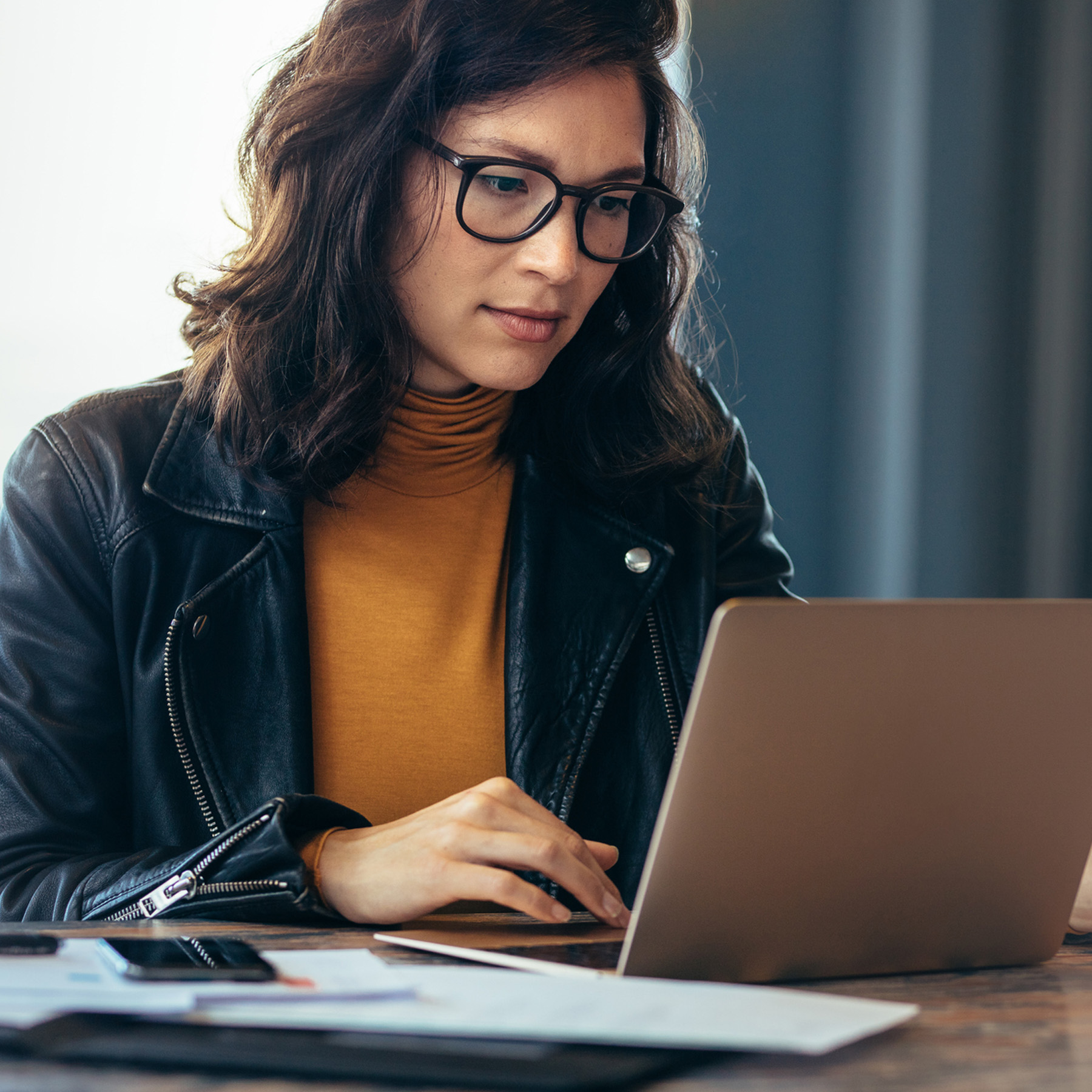 casual professional woman using laptop